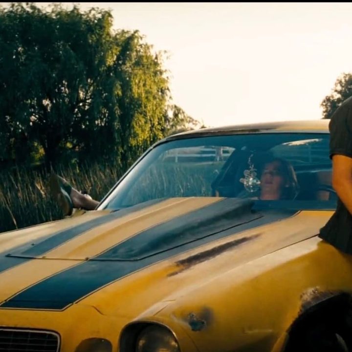 Shia LaBeouf stands against his car in Transformers.
