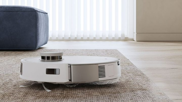 The T20 Omni traveling across a rug with its mops raised.