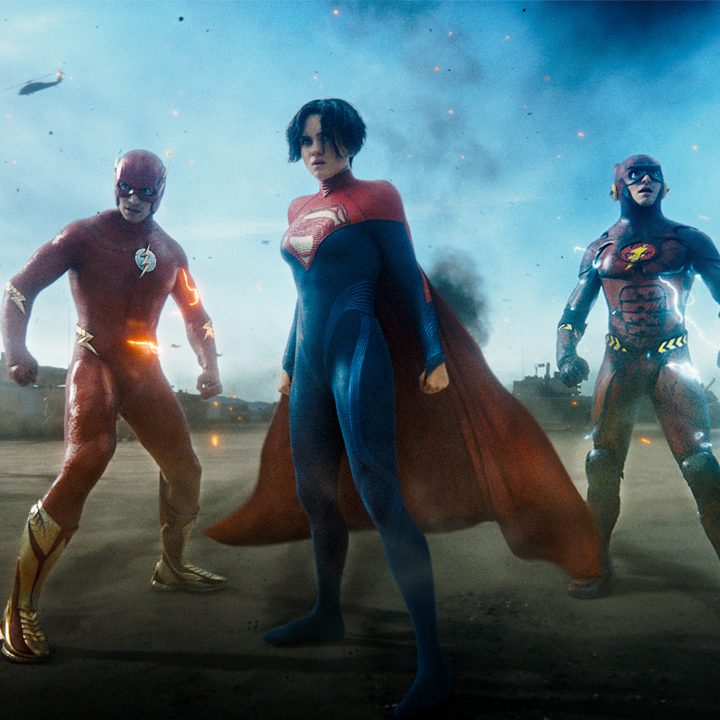 Two Flashes stand on a battlefield with Supergirl in The Flash.