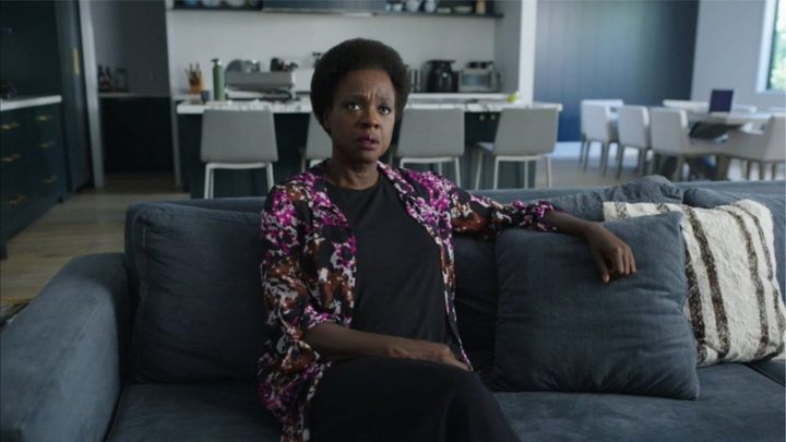 Viola Davis as Amanda Waller sitting on a couch in Peacemaker.