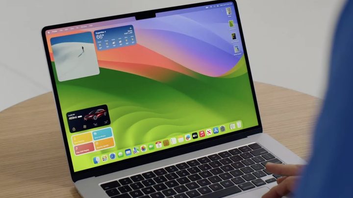 Apple's 15-inch MacBook Air on a desk, with macOS Sonoma running on its display.