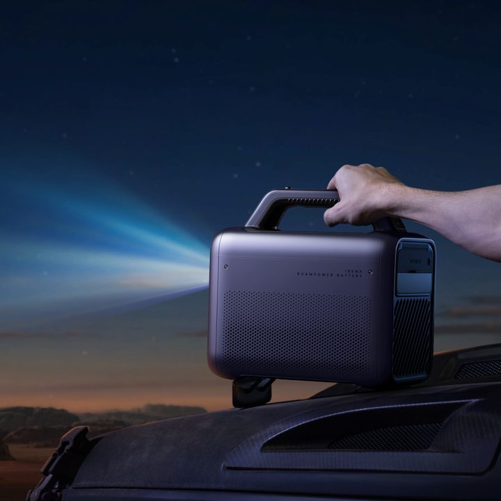 The Anker Nebula Mars 3 outdoor projector shooting a beam of light.