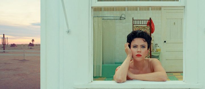 A woman looks out the window in Asteroid City.