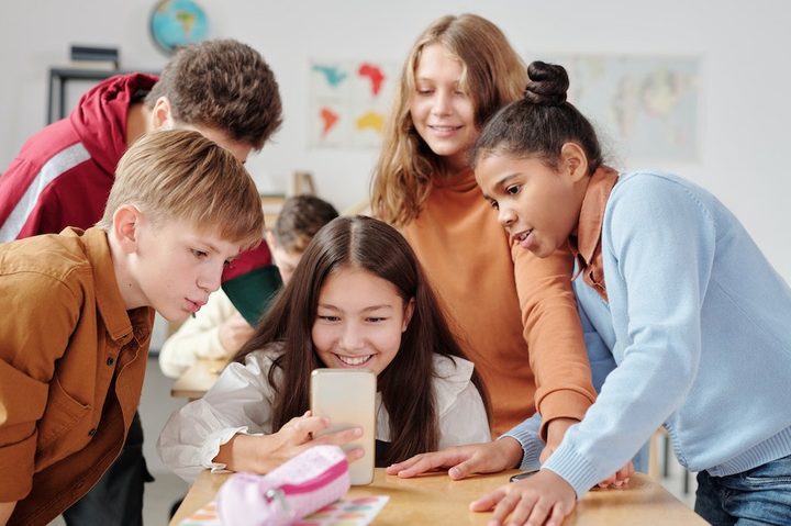 Children using a smartphone.