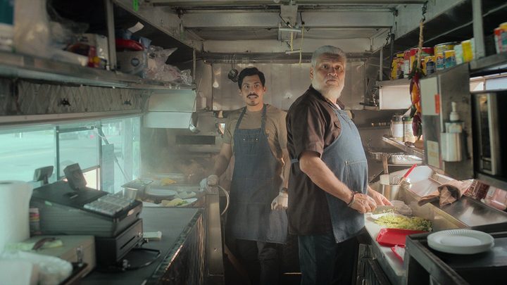 Two men in the back kitchen of a food truck in a scene from Gentified.