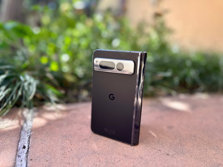 Google Pixel Fold in Obsidian open slightly on a planter.