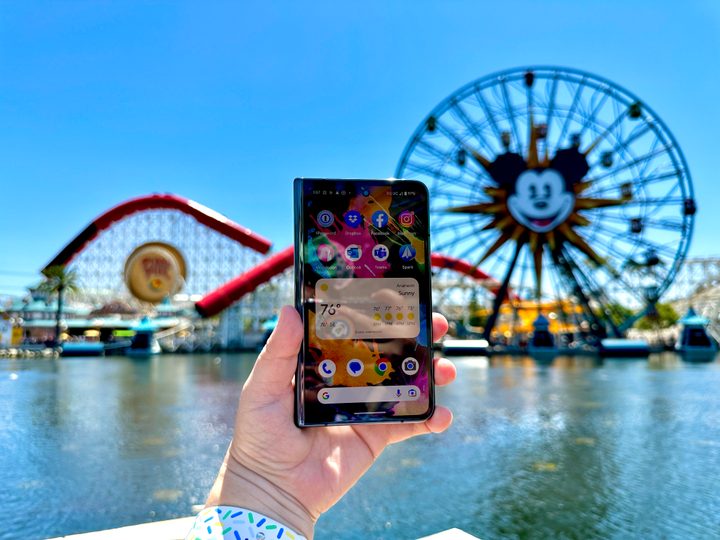 Google Pixel Fold in Obsidian open in hand showing a home screen at Pixar Pier.