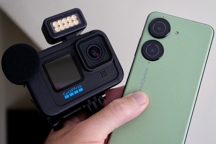The Asus Zenfone 10 held with a GoPro Hero 11 Black.