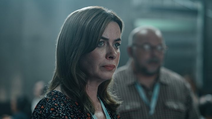Alice looking calm in the air traffic control room in a scene from Hijack.