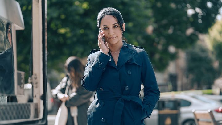 Archie Panjaba in Hijack, on the phone while walking down the street.