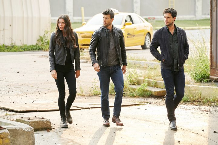 Three people stand next to each other in Imposters.