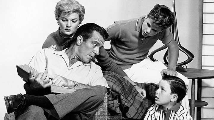 A father reads the paper in Leave it to Beaver.