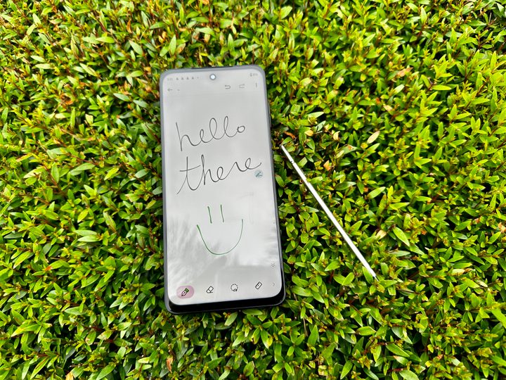 Moto G Stylus 5G 2023 in bush with handwritten note that reads "Hello There."