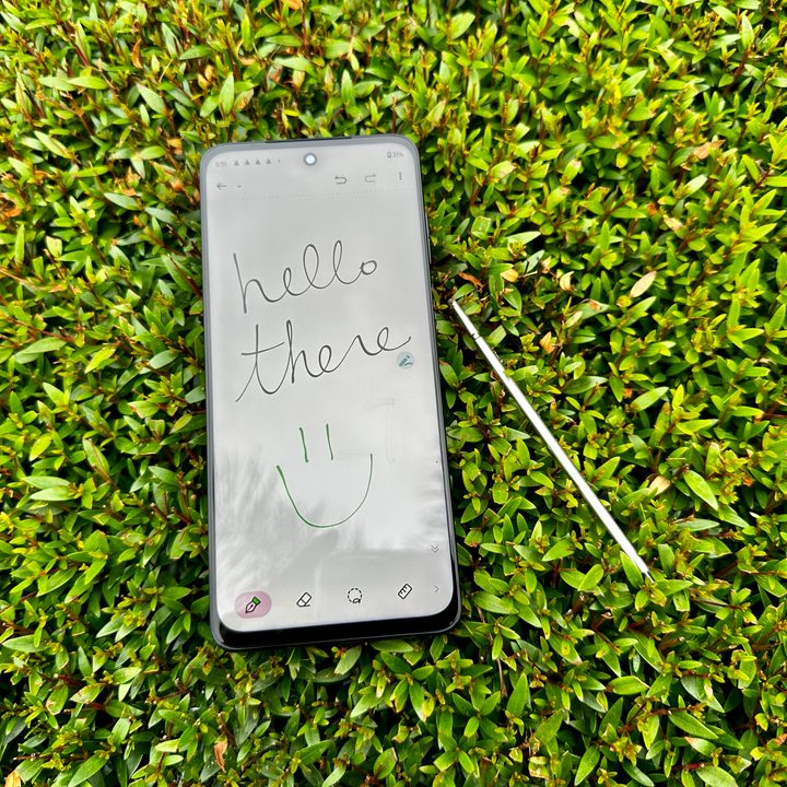 Moto G Stylus 5G 2023 in bush with handwritten note that reads "Hello There."