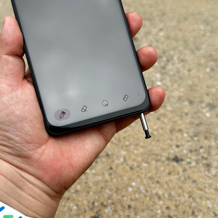 Moto G Stylus 5G 2023 in hand with stylus popped out.