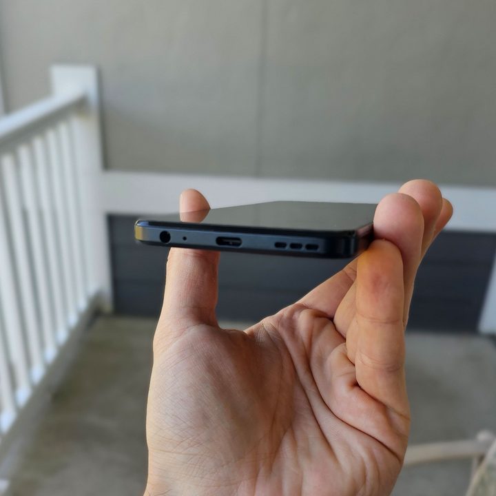 The Moto G 5G held to show off its USB-C charging port, speakers, and headphone jack.