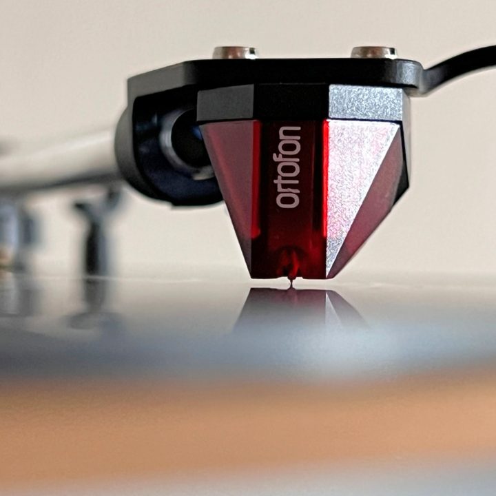 The Ortofon 2M Red turntable cartridge on a headshell.