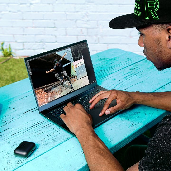 Someone using the Razer Blade 14 on a table.