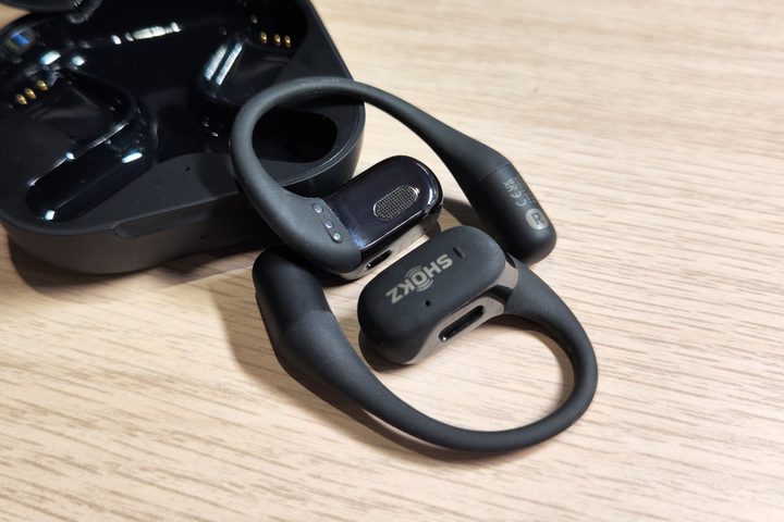 Shokz OpenFit in front of charging case.