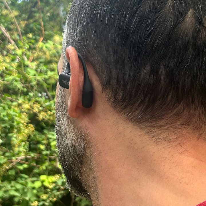 Man wearing Shokz OpenFit (rear view).