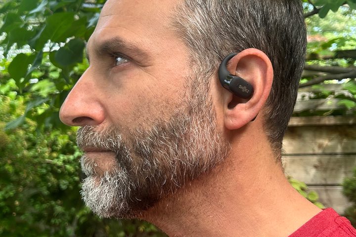 Man wearing Shokz OpenFit (side view).