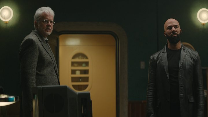 Bernard and Sims looking at something in a scene from Apple TV+'s Silo.