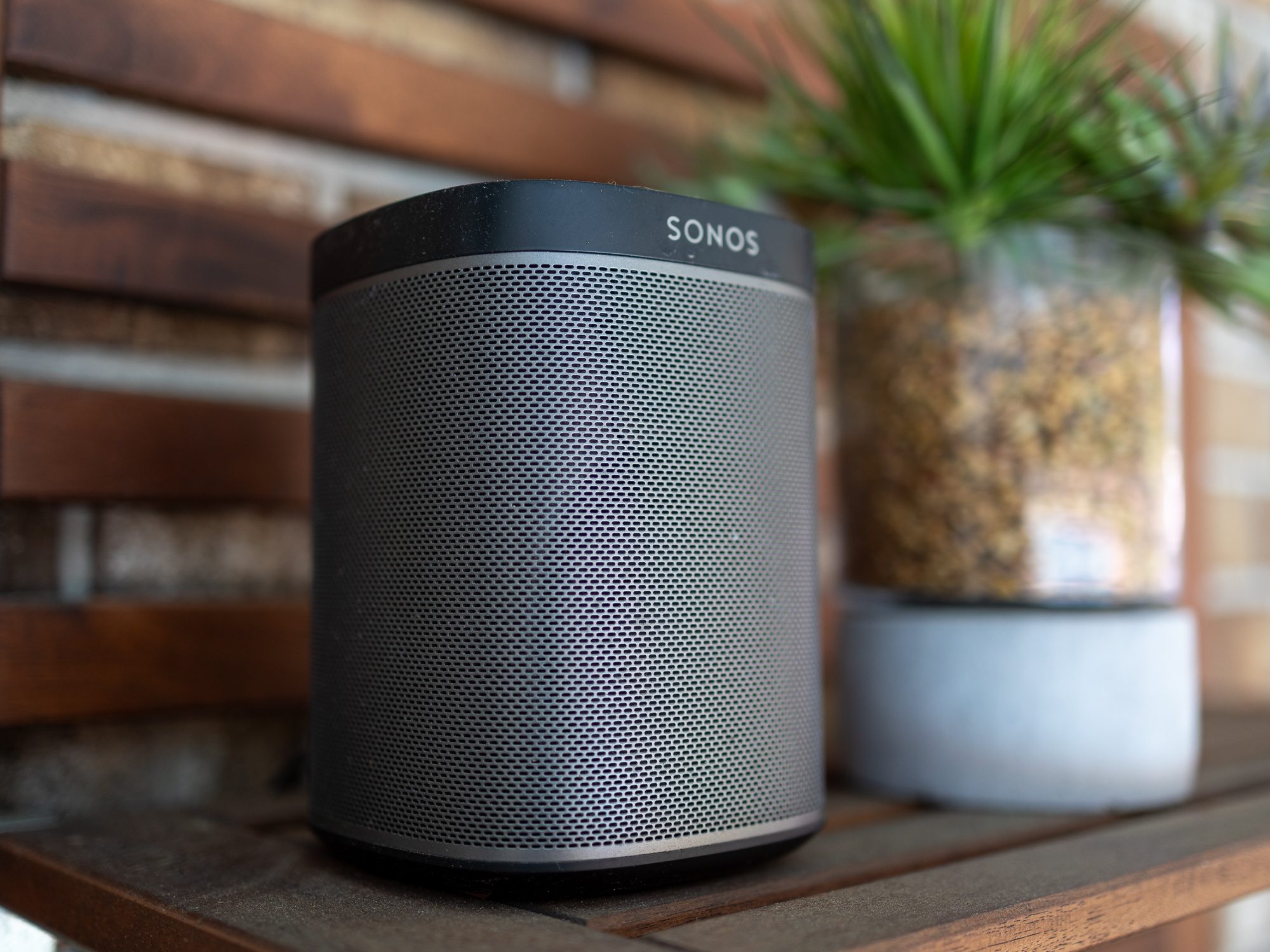 A Sonos Play:1 on a shelf outside.
