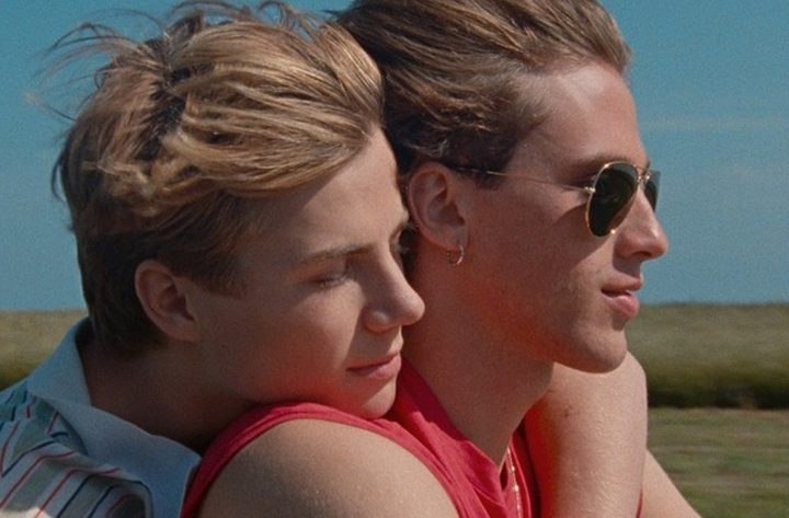 A man rides a motorcycle with another man in Summer of '85.