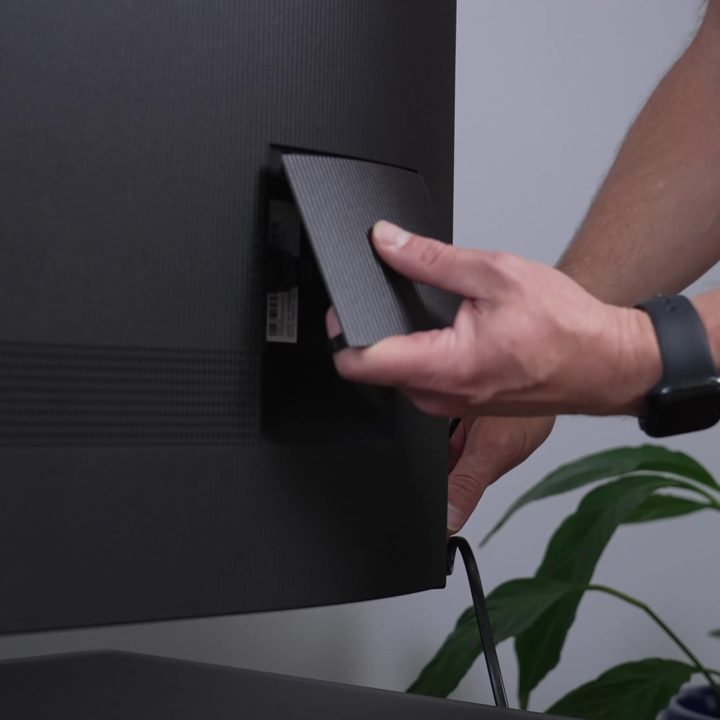 A rear panel is put in place on a TCL QM8.