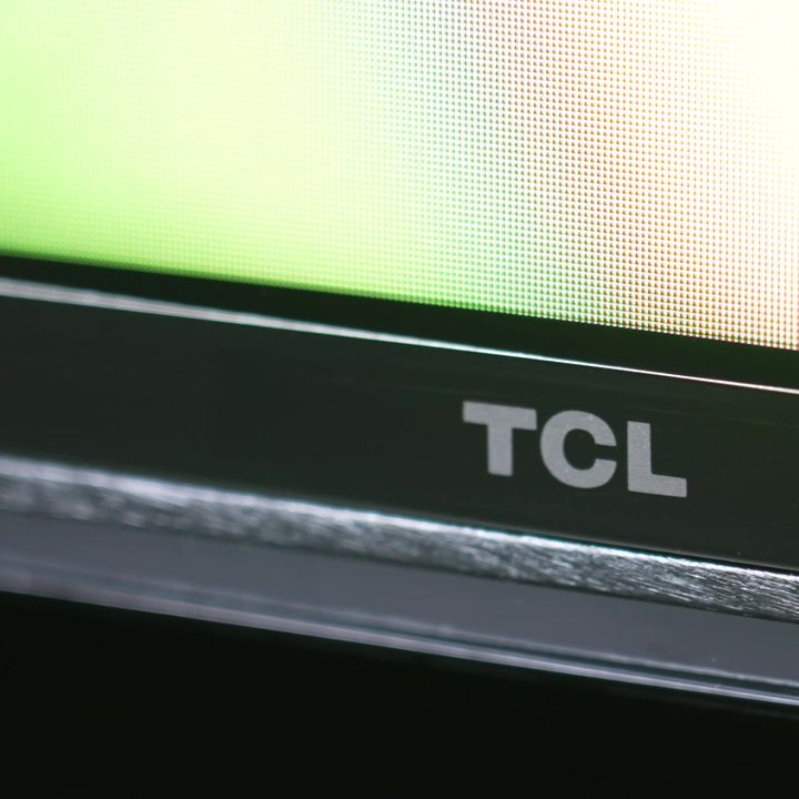 The bottom bezel and logo on a TCL QM8.