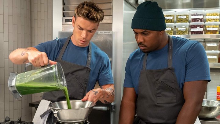 Luca pouring a green mixture through a sieve while Marcus looks on in a scene from The Bear season 2.