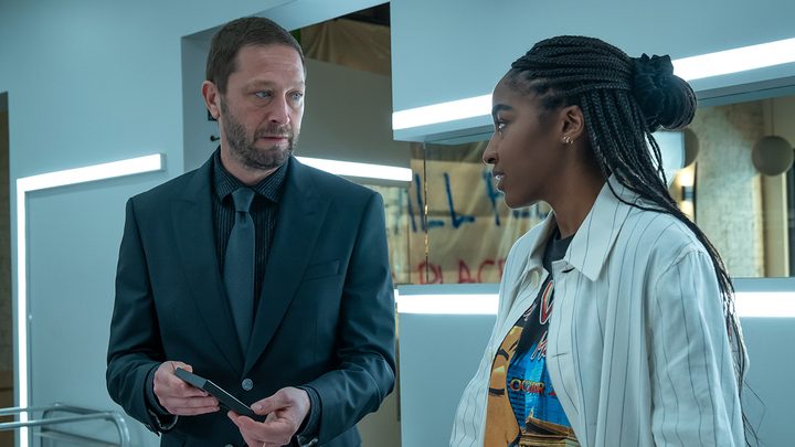 Richie in a suit talking to Sydney in a scene from The Bear season 2.