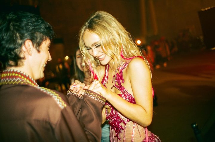 A woman laughs with a friend in The Idol.