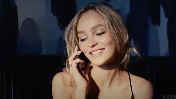 A woman talks on a phone in The Idol.