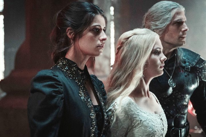 Three people stand next to each other in The Witcher.
