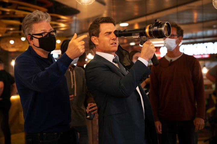 Christopher McQuarrie stands behind Tom Cruise on the set of Mission: Impossible - Dead Reckoning Part One.
