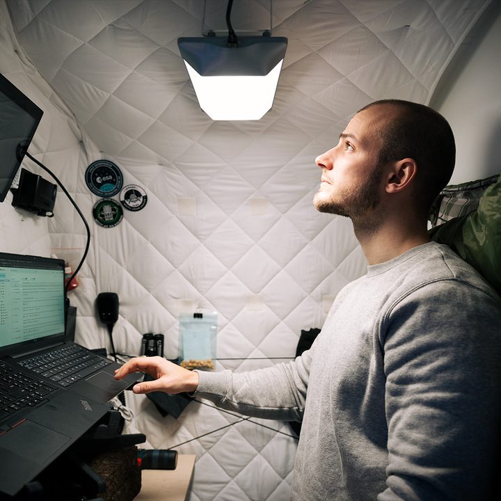 A man works in a small room with a Circadian Light in a daylight setting.