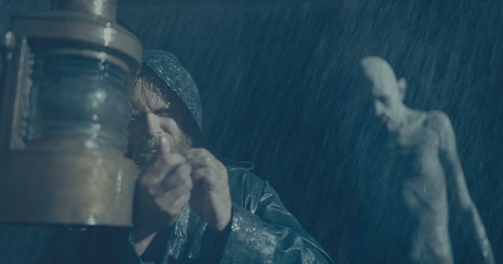 A creature stalks a man in the rain in The Last Voyage of the Demeter.