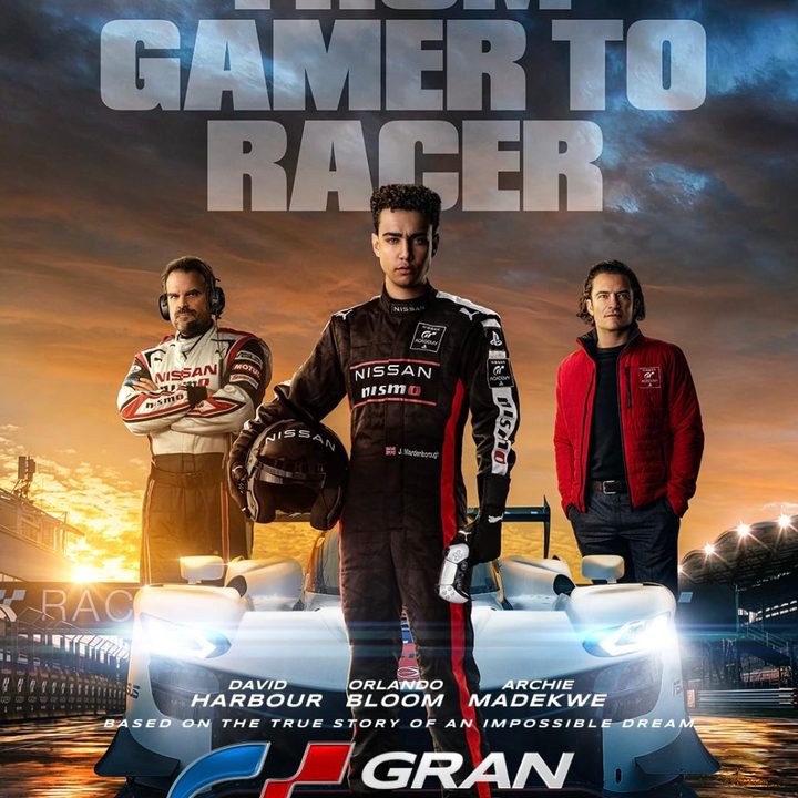 Three men stand on the poster for Grqn Turismo.