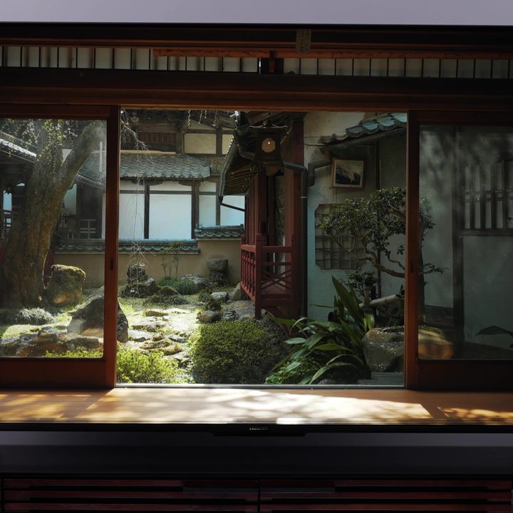A view of a Japansese courtyard looking from within a house displayed on a Hisense U8K.