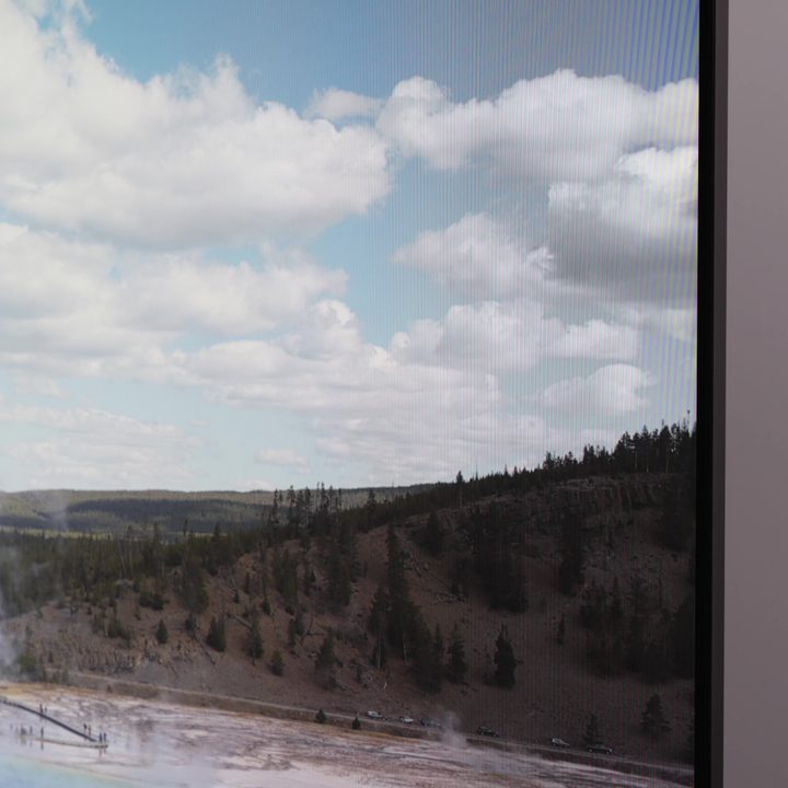 The top right corner of a Hisense U8K TV showing some distortion in the image of a landscape.