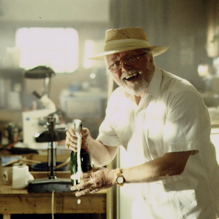 Richard Attenborough pops some champagne.