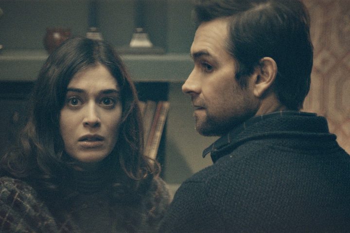 A man and a woman look scared in Cobweb.