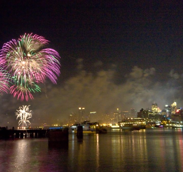 Fireworks explode over the New York City skyline.