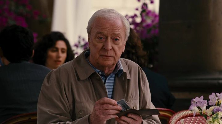 Michael Caine as Alfred at a restaurant in The Dark Knight Rises.
