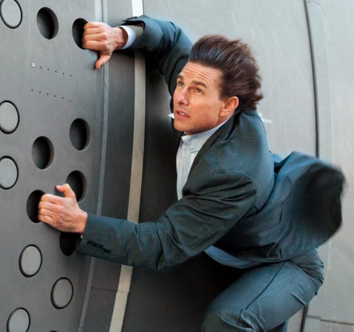 Tom Cruise holds onto the side Mission: Impossible Rogue Nation.
