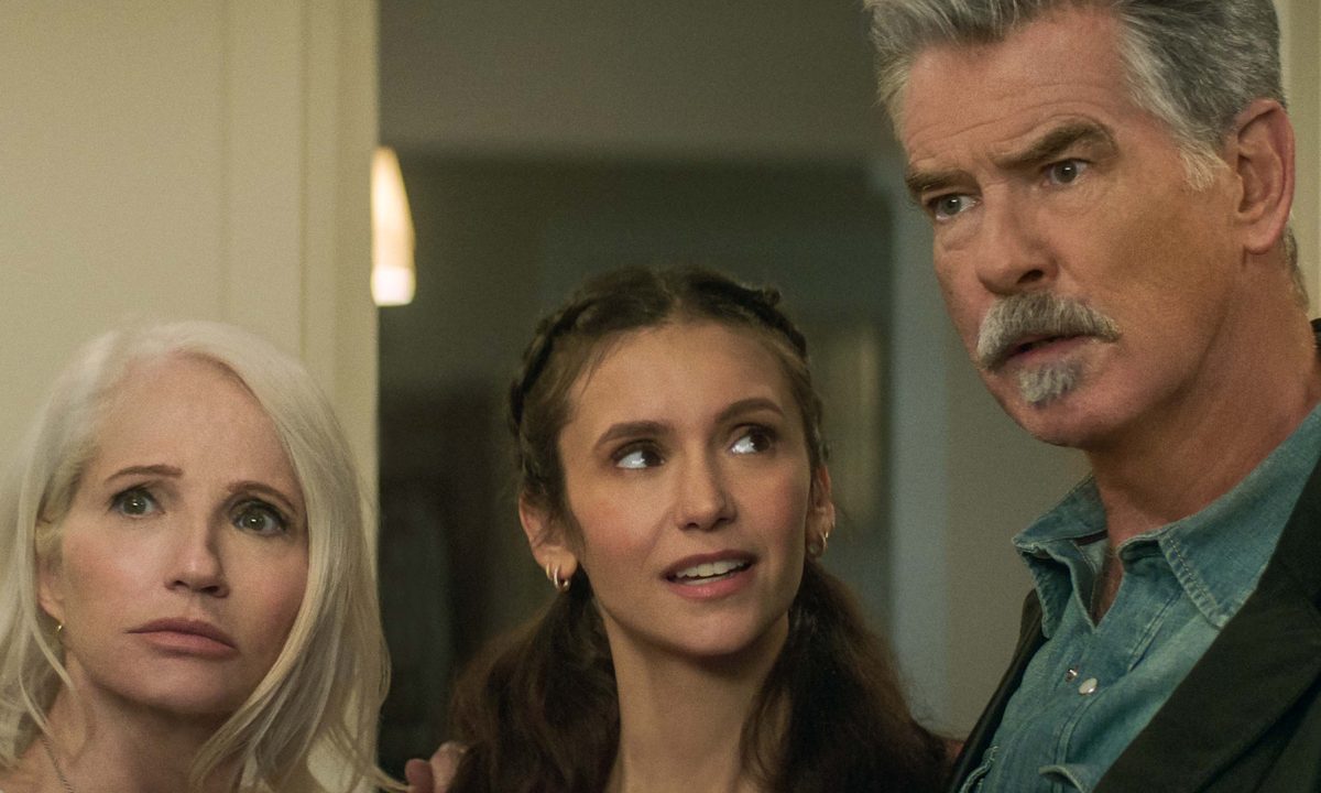 Nina Dobrev looks up at Pierce Brosnan in The Out-Laws.