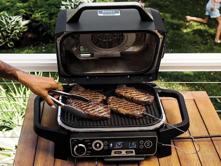 Cooking meat on the Ninja Woodfire Pro outdoor grill and smoker.