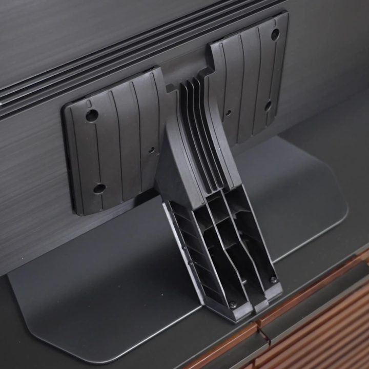A closeup of the stand and cord management on a Samsung QN90C.