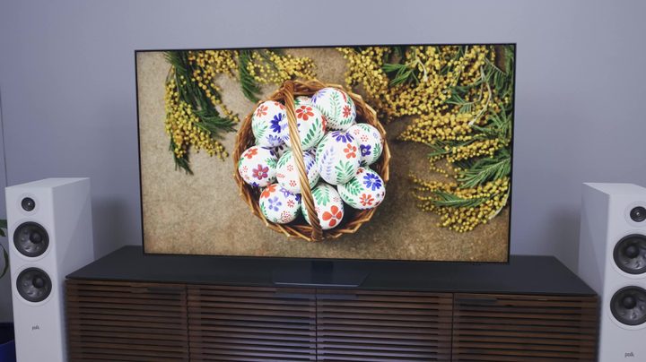 Brightly colored painted eggs in a bowl shown on a Samsung QN90C.
